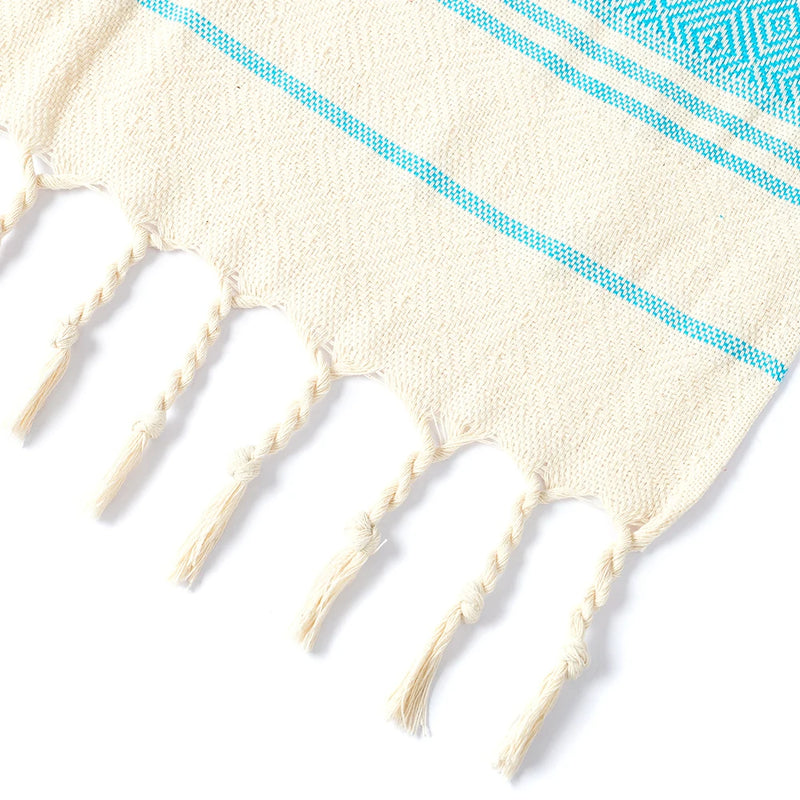 Serviette de plage coton motif jacquard losanges pompons
