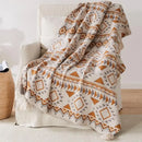 Plaid tricoté style bohème motifs géométriques avec pompons