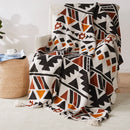 Plaid tricot motif geometrique boheme avec pompons doux