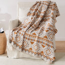 Plaid tricot motif geometrique boheme avec pompons doux