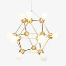 Lustre design géométrique avec plusieurs bras dorés et boules Molecule