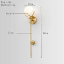 Applique murale design LED avec tige en métal doré et marbre