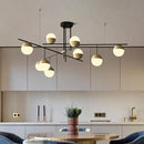 Lustre design avec branches et boules en verre et métal doré