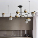 Lustre design avec branches et boules en verre et métal doré