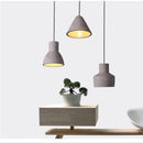 Suspension design à LED avec abat-jour arrondie en ciment