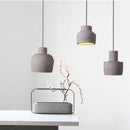 Suspension design à LED avec abat-jour arrondie en ciment